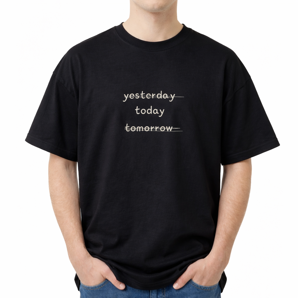 Person wearing a black t-shirt with 'yesterday today tomorrow' text on a white background. The center chest features three stacked words in a lowercase, casual font: "yesterday", "today", and "tomorrow". The words "yesterday" and "tomorrow" are crossed out with horizontal lines, leaving only the middle word "today" uncrossed and clearly legible.