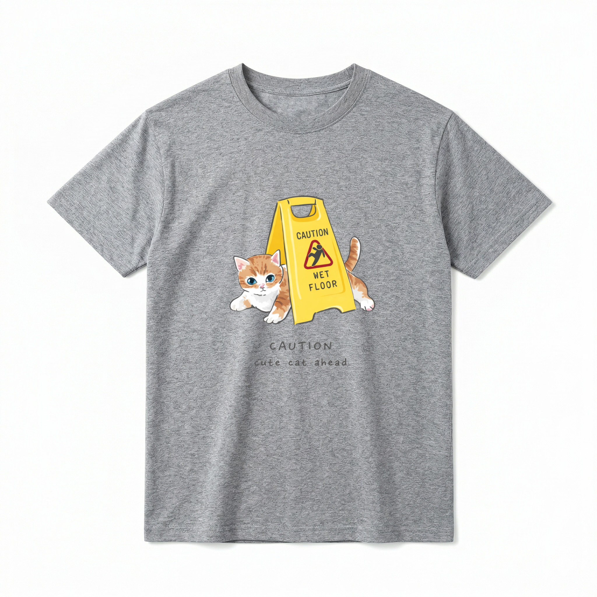 A flat lay of a short-sleeve t-shirt. The center chest features a graphic of a small orange and white kitten peeking out from behind a bright yellow "CAUTION WET FLOOR" A-frame sign. Below the illustration, the text reads "CAUTION cute cat ahead" in a playful, casual font.