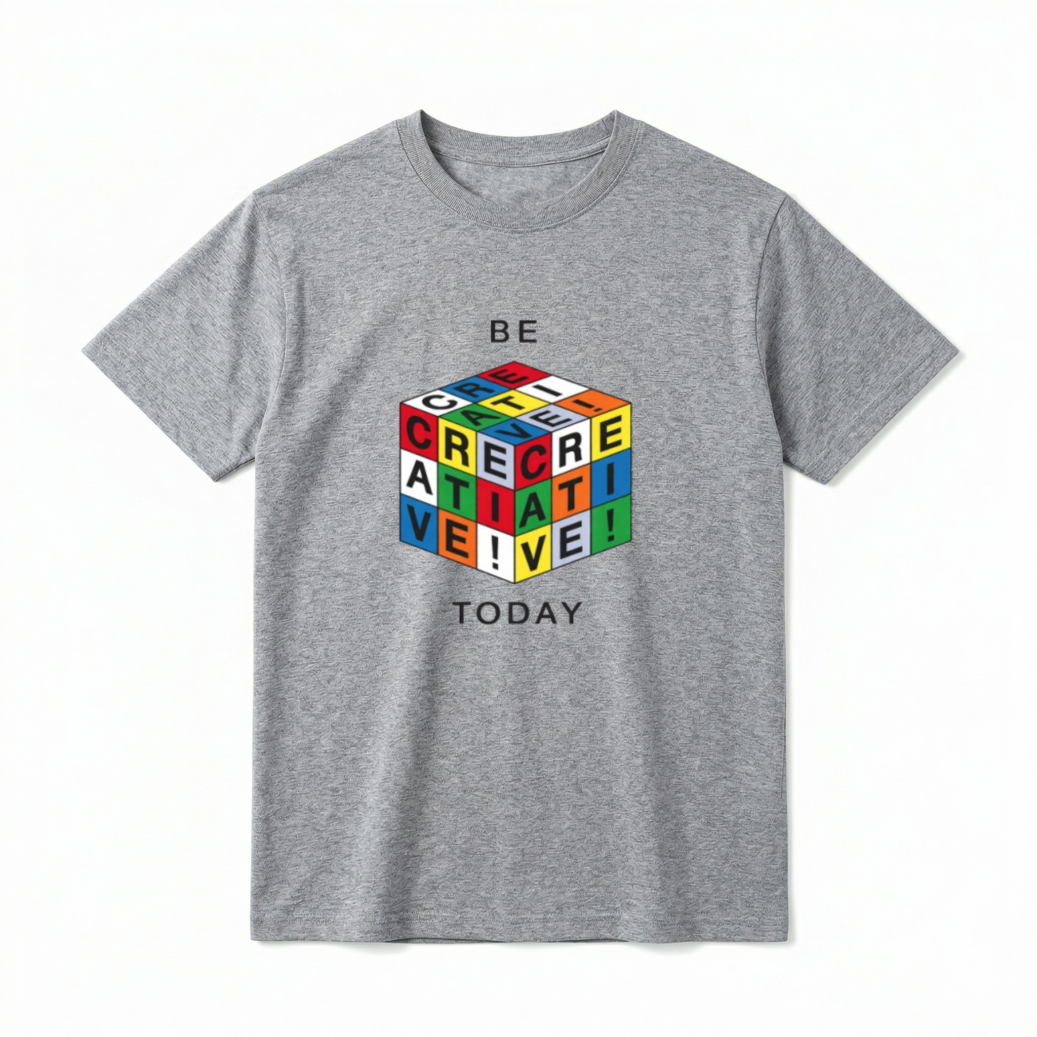 A flat lay of a short-sleeve t-shirt. The center chest features a graphic of a 3D puzzle cube with brightly colored grid squares in red, blue, green, yellow, orange, and white. The black letters across the visible grids spell out "CREATIVE!". Above the cube is the text "BE" and below the cube is the text "TODAY" in a simple, modern black font.