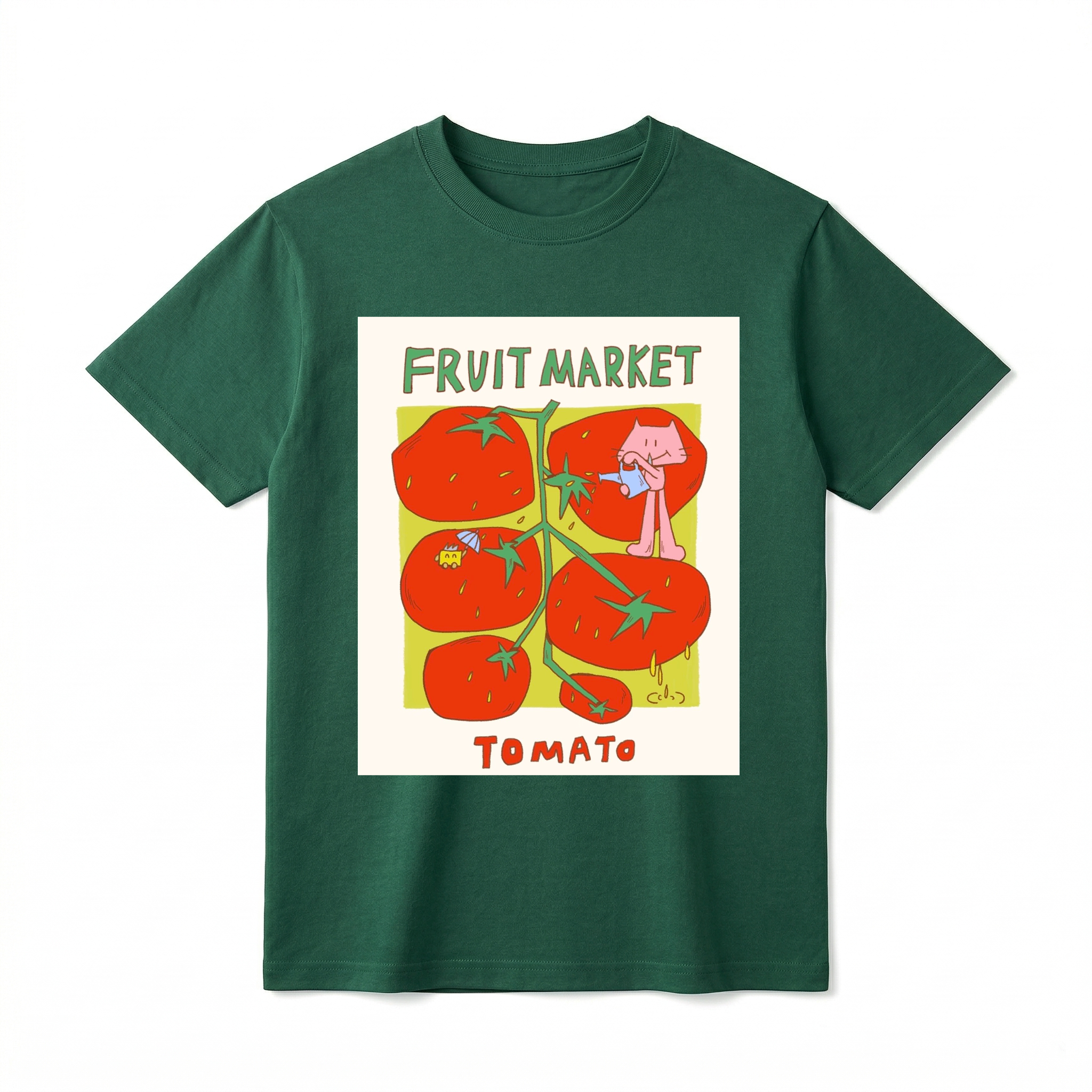 A flat lay of a short-sleeve t-shirt. The center features a colorful graphic with the text "FRUIT MARKET" at the top in green, hand-drawn letters. Below it is a light green square containing illustrations of a vine with five large, bright red tomatoes. A cute pink cartoon cat stands on one of the tomatoes, pouring water from a small blue watering can. Another tomato features a tiny yellow creature holding a blue umbrella. The word "TOMATO" is printed at the bottom in bold red text.