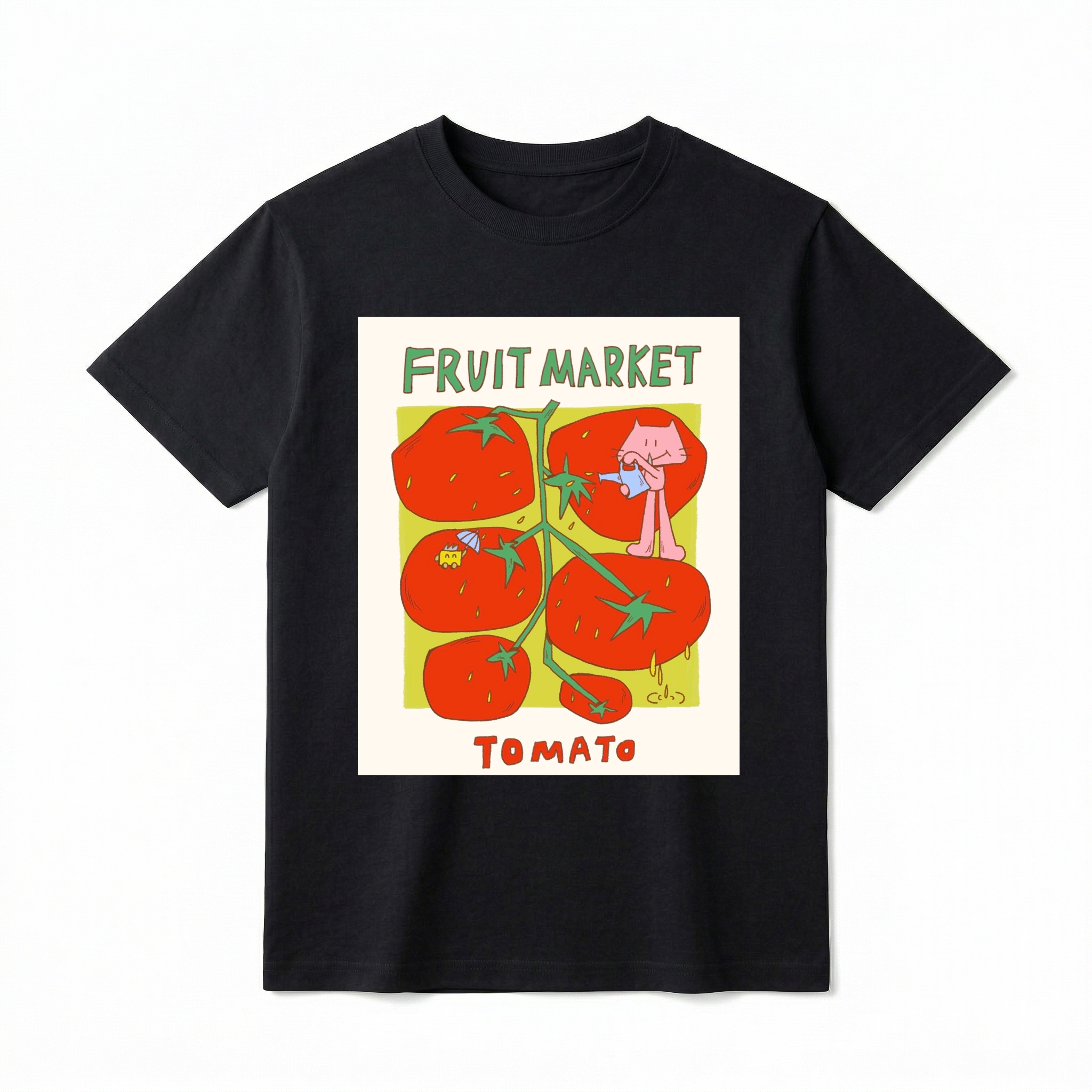 A flat lay of a short-sleeve t-shirt. The center features a colorful graphic with the text "FRUIT MARKET" at the top in green, hand-drawn letters. Below it is a light green square containing illustrations of a vine with five large, bright red tomatoes. A cute pink cartoon cat stands on one of the tomatoes, pouring water from a small blue watering can. Another tomato features a tiny yellow creature holding a blue umbrella. The word "TOMATO" is printed at the bottom in bold red text.