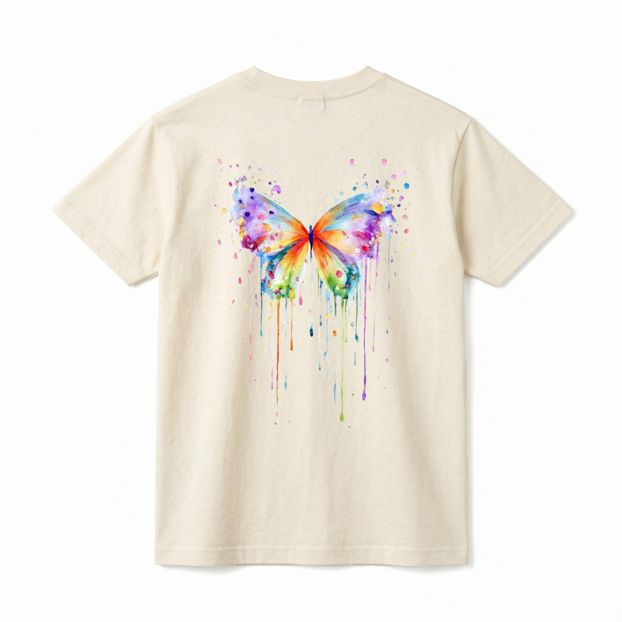 A flat lay showing the back of a short-sleeve t-shirt. The center features a large, vibrant watercolor painting of a butterfly. The butterfly's wings are filled with a rainbow of blended colors, including purple, blue, orange, yellow, and green. The design incorporates artistic paint splatters around the top and long, colorful watercolor drips running down from the bottom edges of the wings.