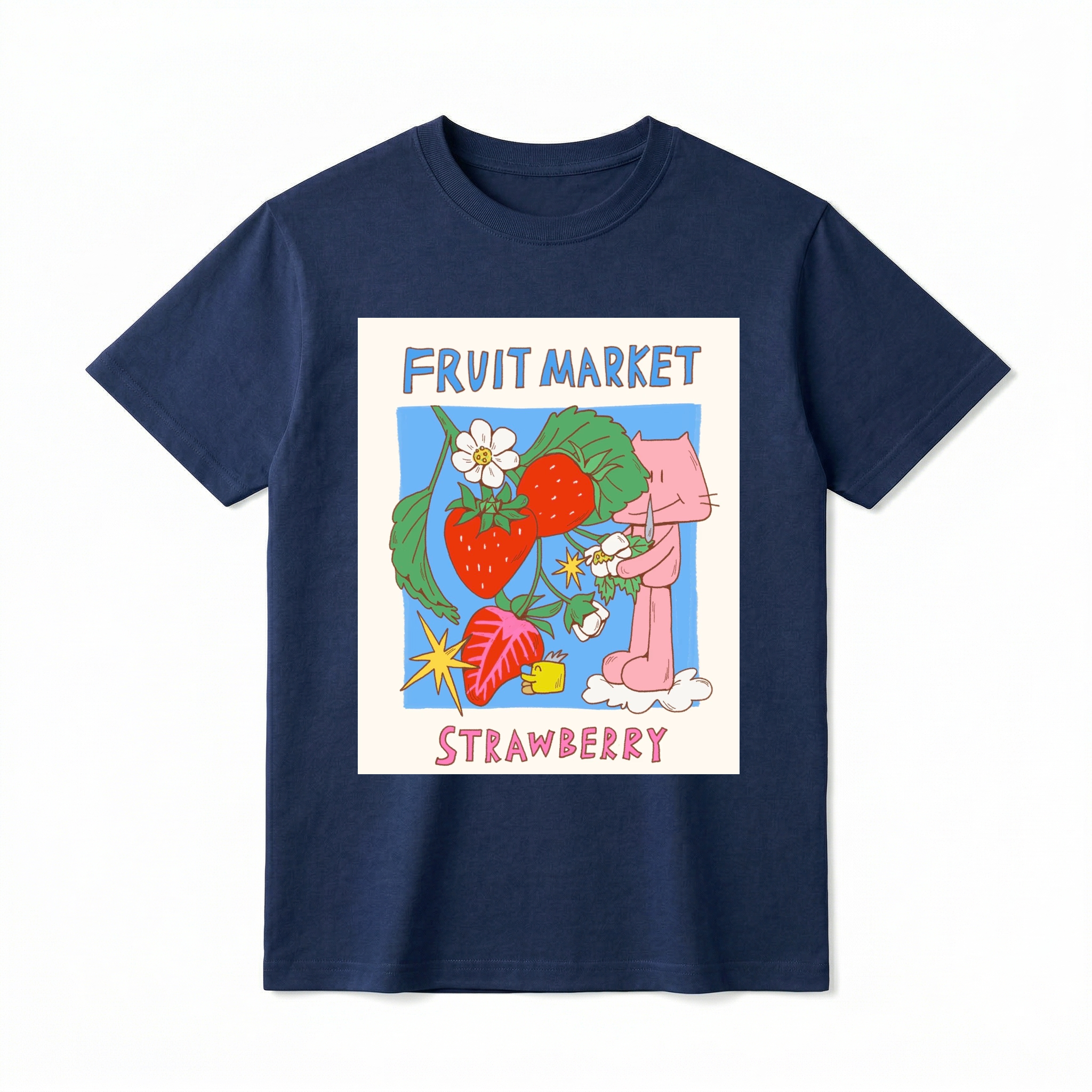 A flat lay of a short-sleeve t-shirt. The center features a colorful graphic with the text "FRUIT MARKET" at the top in blue, hand-drawn letters. Below it is a light blue square containing illustrations of bright red strawberries on a leafy green vine with white blossoms, a sliced strawberry half, and a retro yellow starburst. On the right side, a cute pink cartoon cat stands on a small white cloud, holding a little flower. The word "STRAWBERRY" is printed at the bottom in bold pink text.
