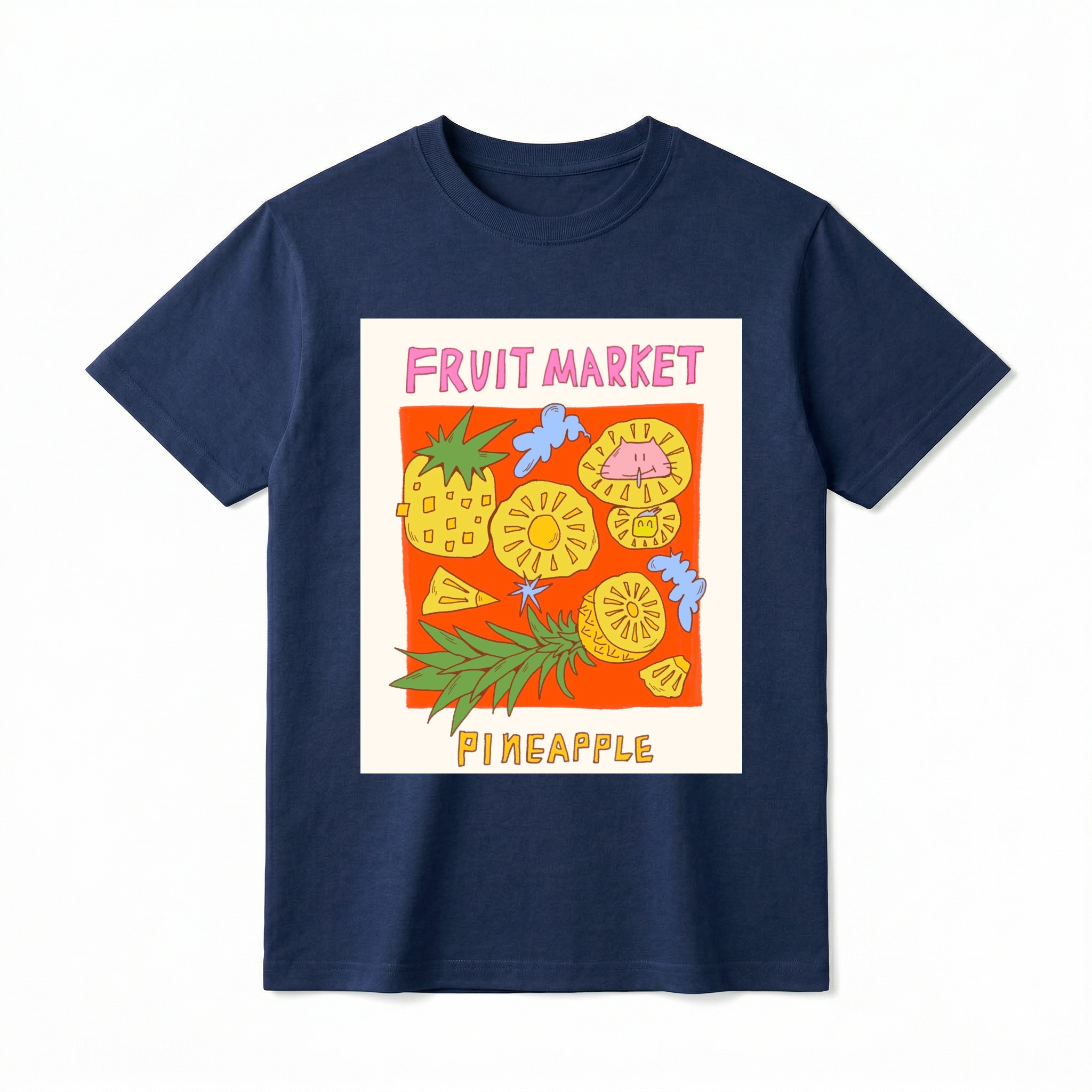 A detailed flat lay of a short-sleeve t-shirt. The center features a prominent graphic of a colorful, kitschy "Fruit Market" panel. The art includes a whole pineapple, various slices and wedges of pineapple, and abstract cloud shapes, with the text "FRUIT MARKET" at the top in pink font and "PINEAPPLE" at the bottom in yellow font.