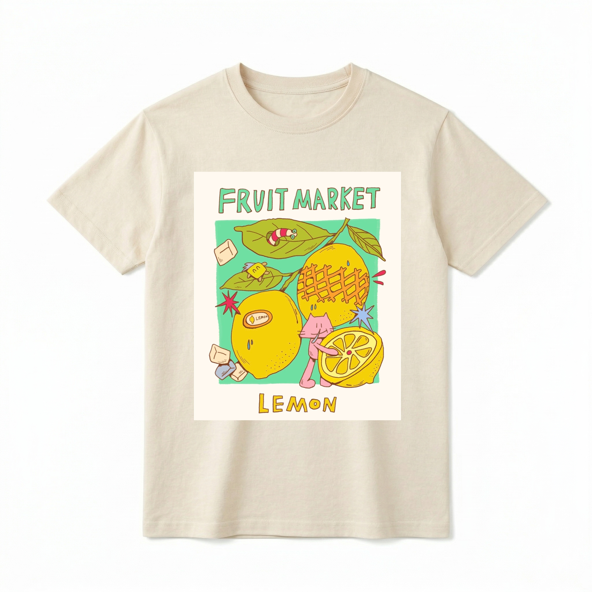 A cream-colored short-sleeve t-shirt. At the top, "FRUIT MARKET" is in hand-drawn blue font. A distressed rectangular graphic panel shows detailed illustrations of two whole lemons and a sliced lemon half. Text below panel reads "LEMON" in hand-drawn yellow-brown font.