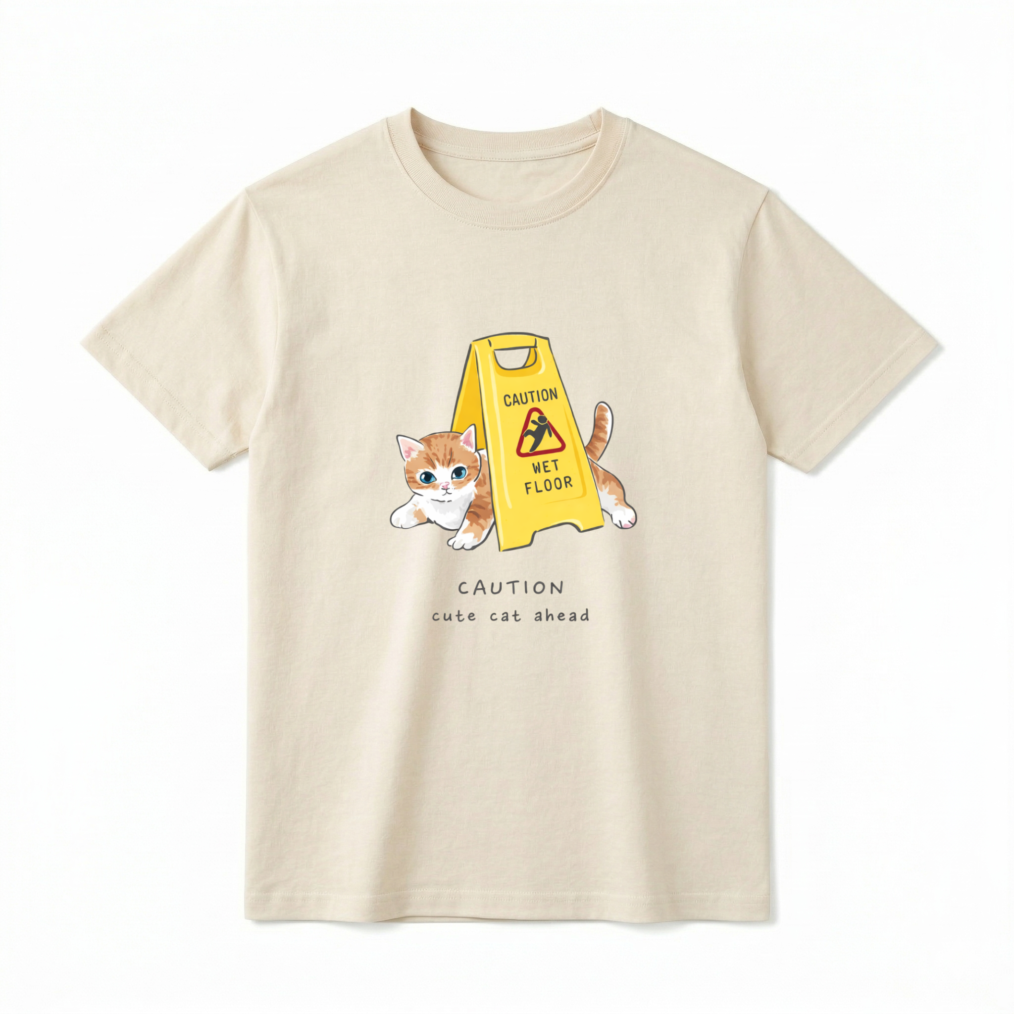 A flat lay of a short-sleeve t-shirt. The center chest features a graphic of a small orange and white kitten peeking out from behind a bright yellow "CAUTION WET FLOOR" A-frame sign. Below the illustration, the text reads "CAUTION cute cat ahead" in a playful, casual font.
