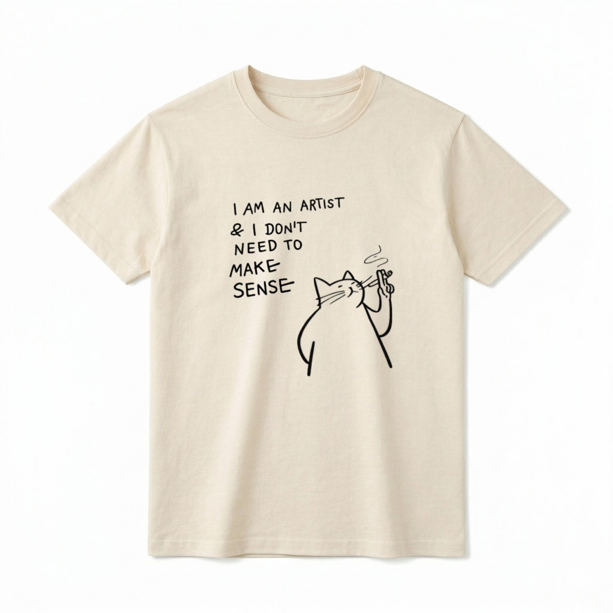 A flat lay of a short-sleeve t-shirt. The center chest features a black minimalist line-art graphic of a smug, chunky cat holding a smoking object. To the left of the cat, playful handwritten-style text reads "I AM AN ARTIST & I DON'T NEED TO MAKE SENSE" stacked in four lines.