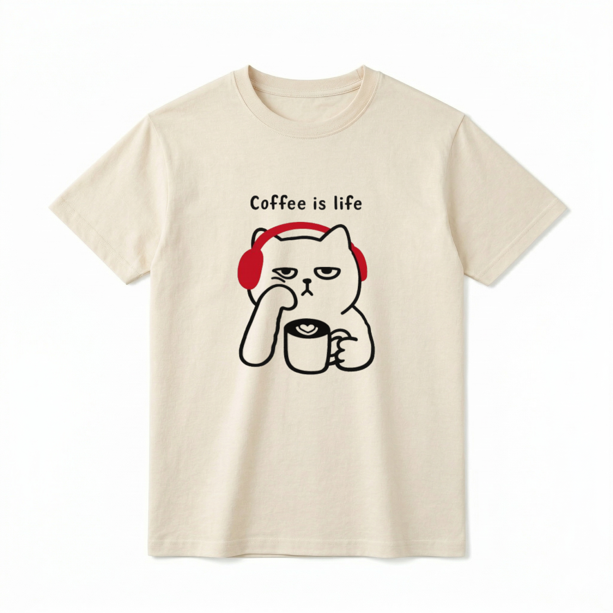 A flat lay of a short-sleeve t-shirt. The center chest features a black line-art graphic of a grumpy-looking cat wearing bright red headphones. The cat is resting its chin on one paw and holding a coffee mug with a latte art heart in the other. Above the cat, the text reads "Coffee is life" in a simple, playful black font.