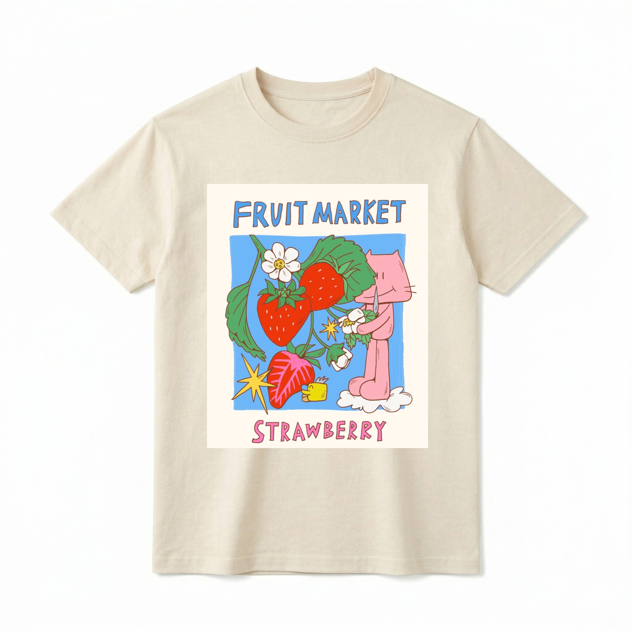 A flat lay of a short-sleeve t-shirt. The center features a colorful graphic with the text "FRUIT MARKET" at the top in blue, hand-drawn letters. Below it is a light blue square containing illustrations of bright red strawberries on a leafy green vine with white blossoms, a sliced strawberry half, and a retro yellow starburst. On the right side, a cute pink cartoon cat stands on a small white cloud, holding a little flower. The word "STRAWBERRY" is printed at the bottom in bold pink text.