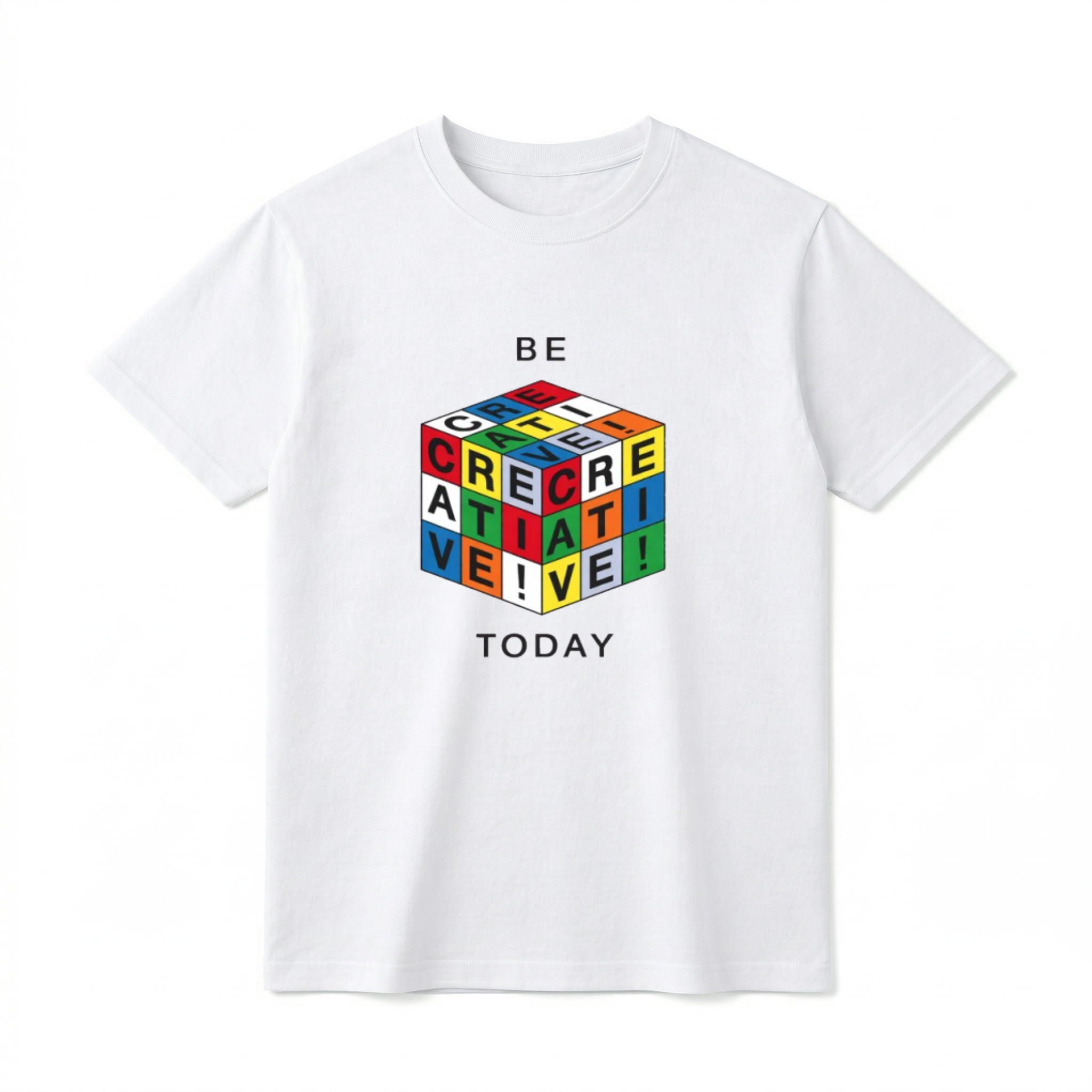 A flat lay of a short-sleeve t-shirt. The center chest features a graphic of a 3D puzzle cube with brightly colored grid squares in red, blue, green, yellow, orange, and white. The black letters across the visible grids spell out "CREATIVE!". Above the cube is the text "BE" and below the cube is the text "TODAY" in a simple, modern black font.