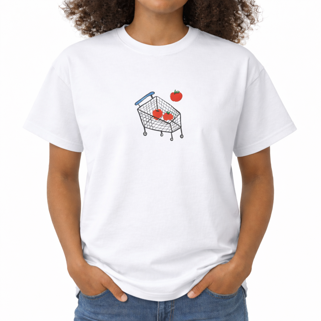 Person wearing a white t-shirt with a shopping cart and apple graphic. The center chest features a minimalist, hand-drawn graphic of a wire shopping cart with a blue handle. Inside the cart are two bright red apples, with a third red apple floating just above the basket as if it is falling in.